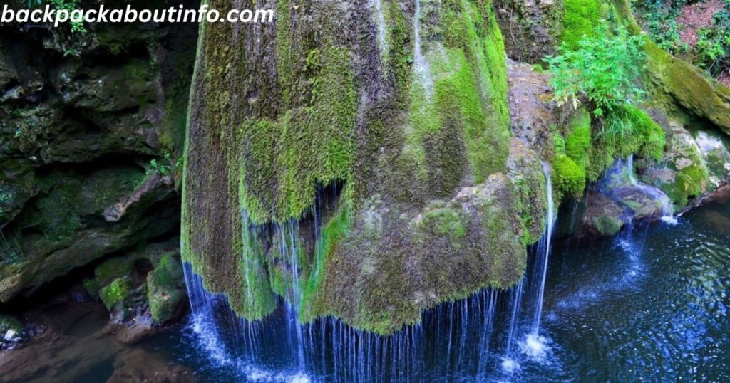 a waterfall over a rock