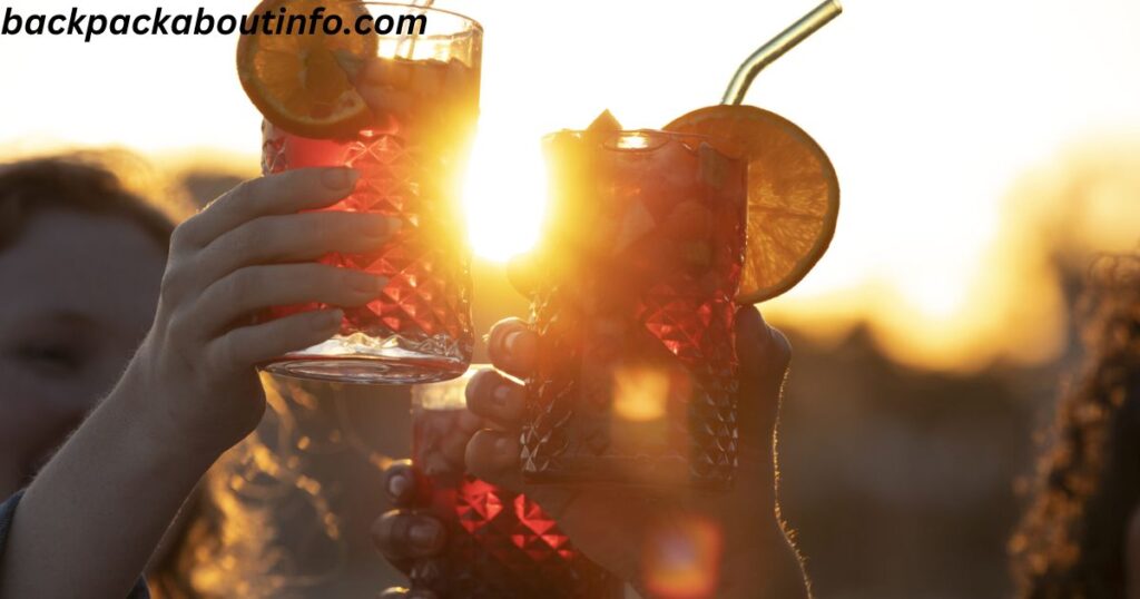 a group of hands holding glasses with drinks